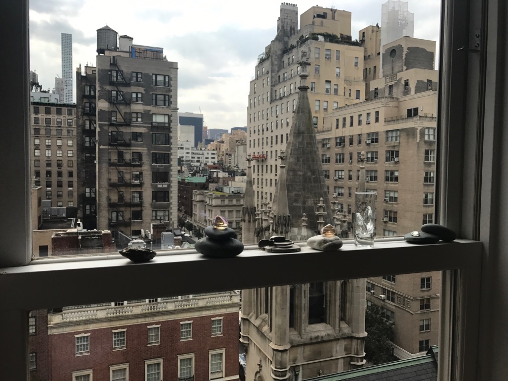 looking out a window at the church's steeple